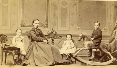 Young boy on rocking horse surrounded by his family by Georg Friedrich Brandseph